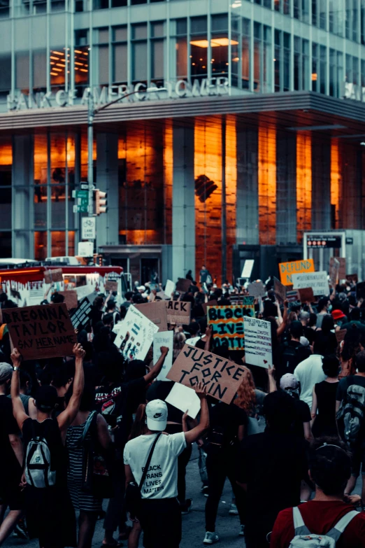 many people are holding up protest signs in the street