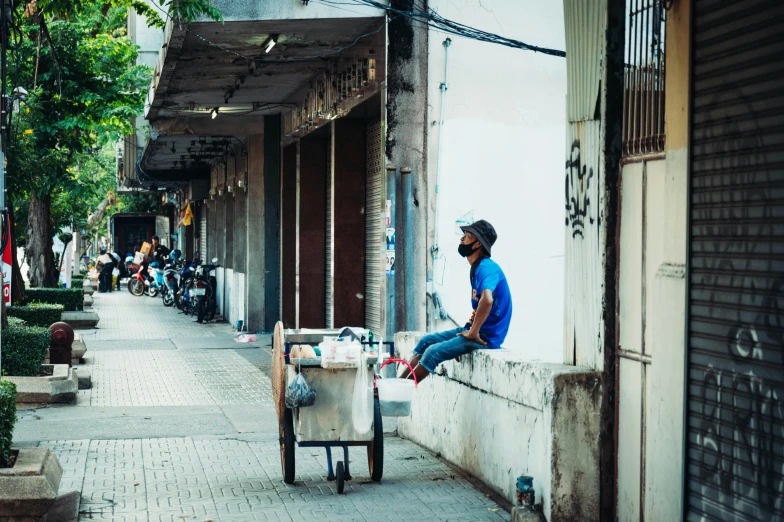 a man sitting on the outside wall of a building