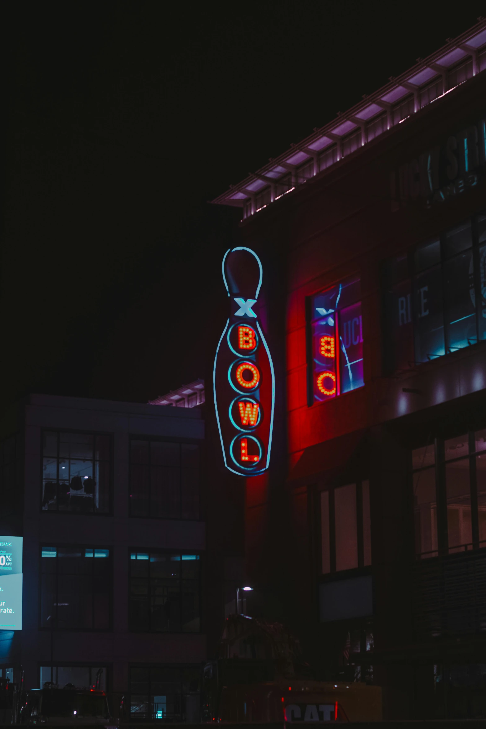 a picture of the outside of a building with neon lights