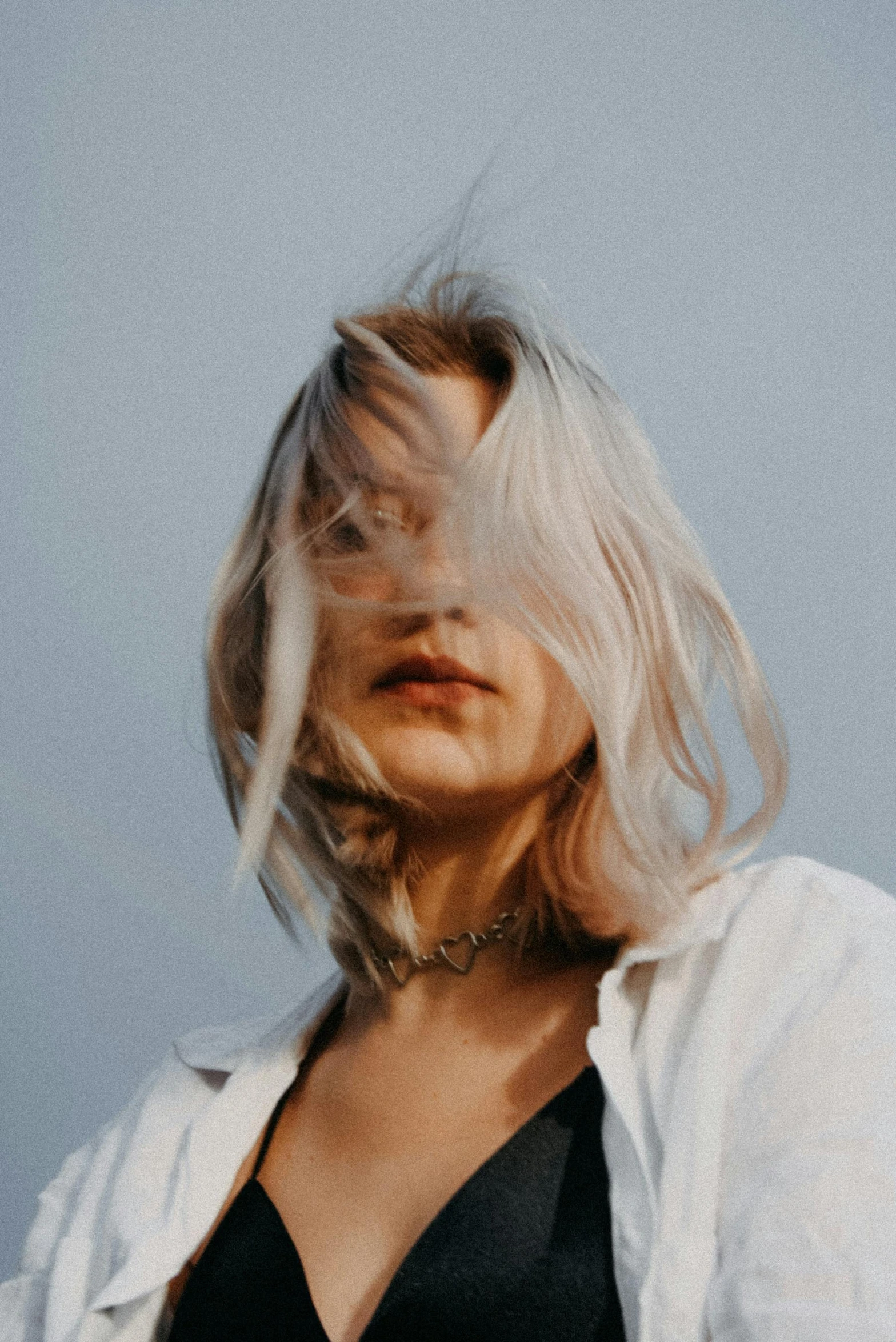 a woman with her hair blowing in the wind