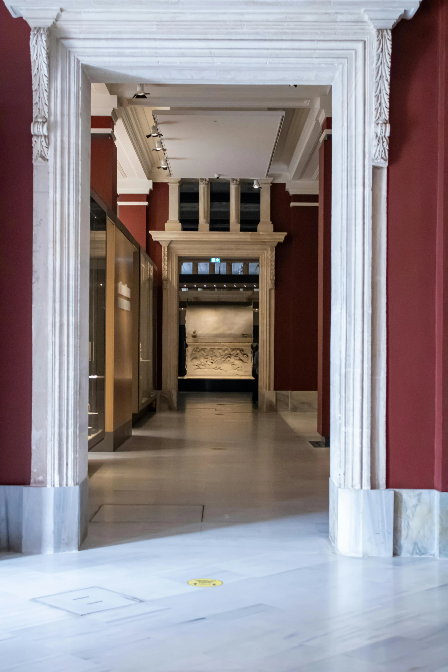 an empty hallway with columns and a podium