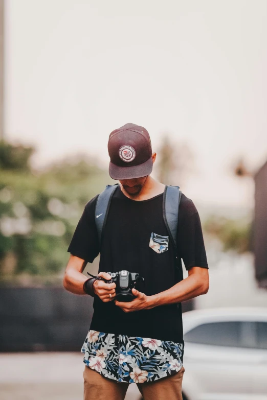 a man is using a cell phone on the street