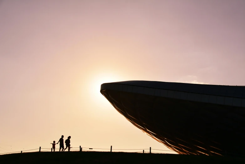 a group of people on a hill near the sun