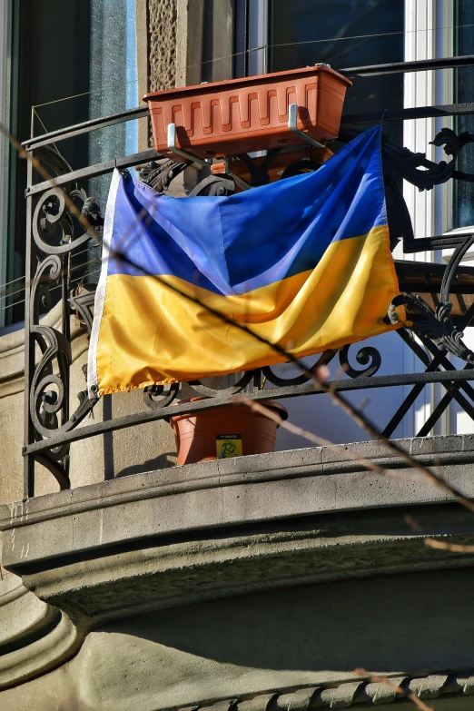 a flag hanging off of a balcony