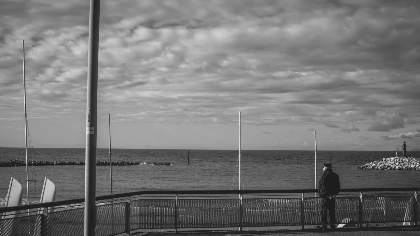 black and white pograph of two men looking out to sea