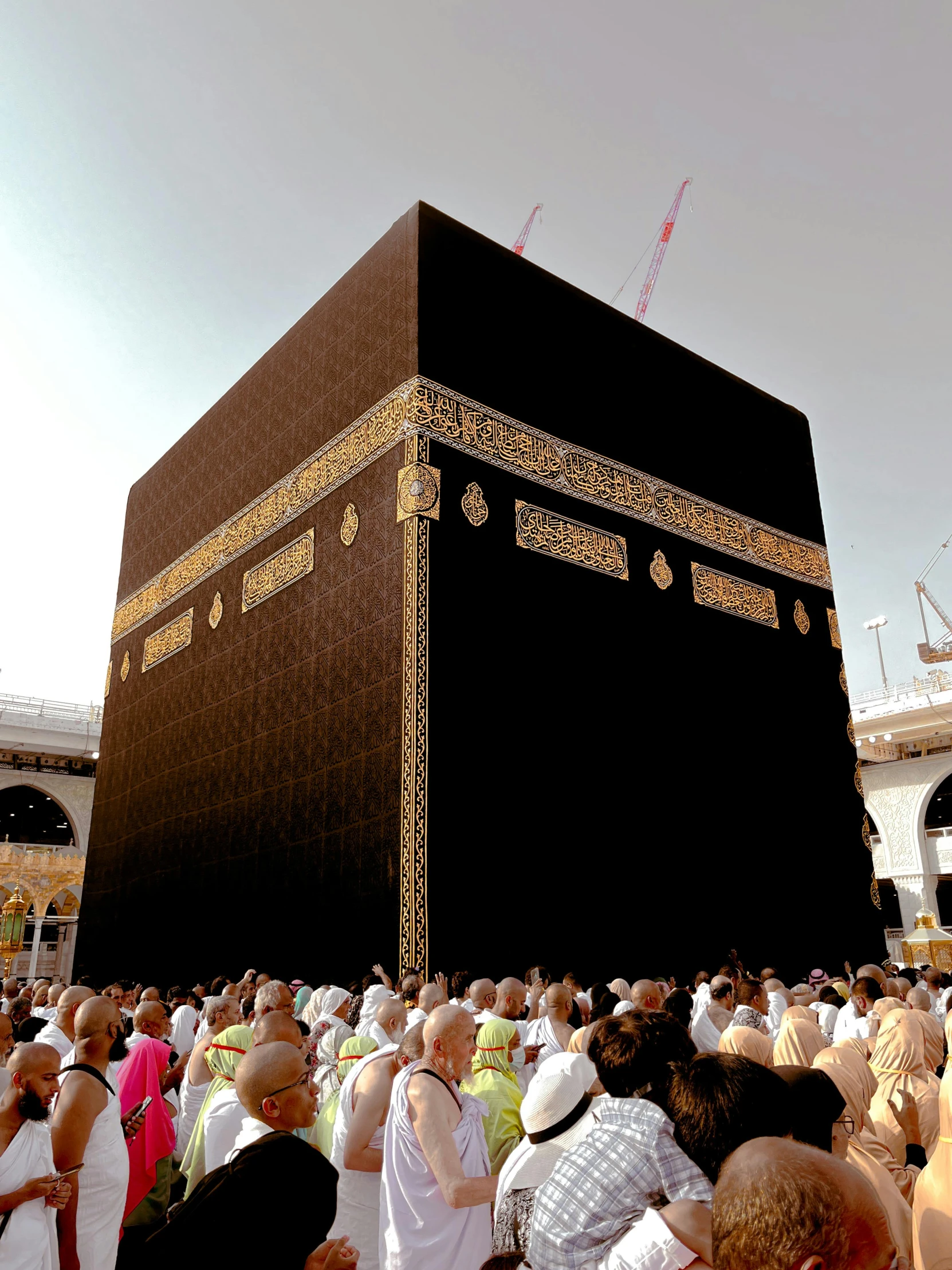 crowds standing around a giant building decorated in gold