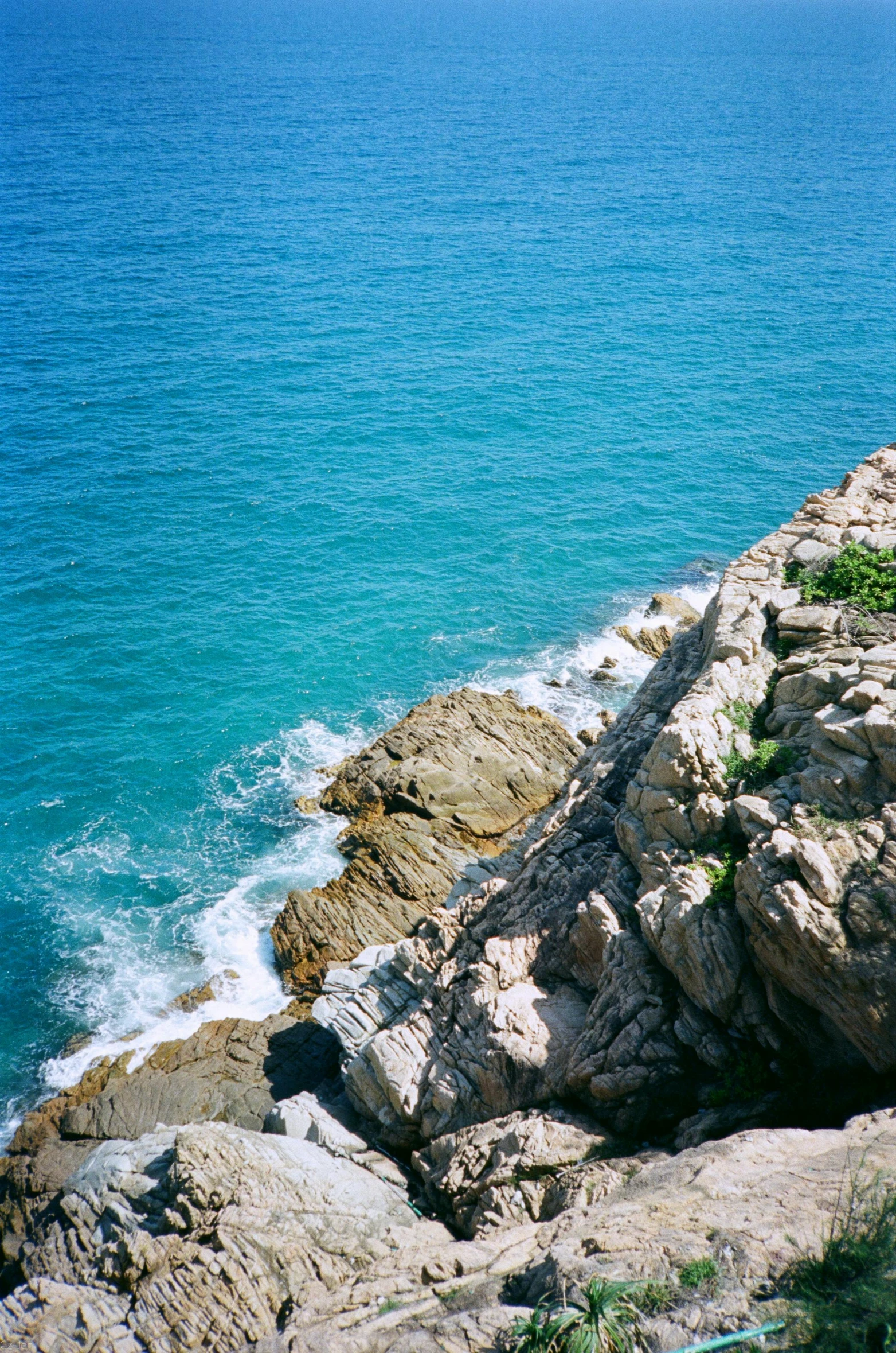 a man riding on the back of a motorcycle down the side of a cliff