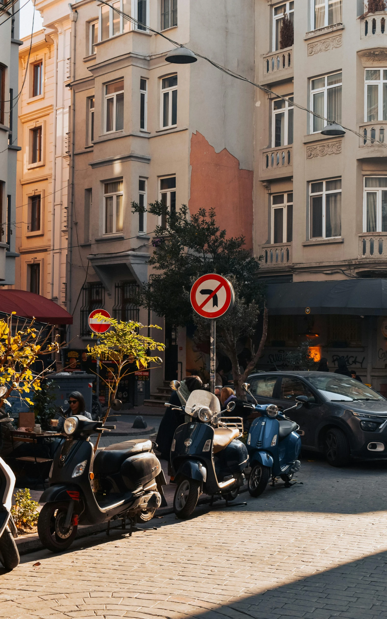 many motorcycles parked near each other next to buildings