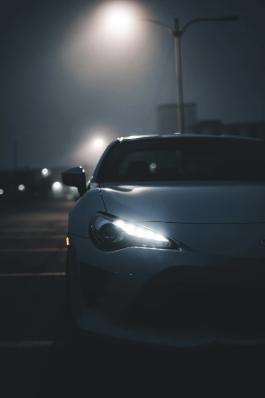 a white sports car driving down the road