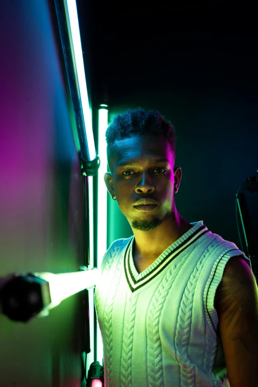 a man standing next to a wall with a baseball bat