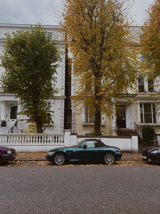 two cars parked next to each other in front of a building