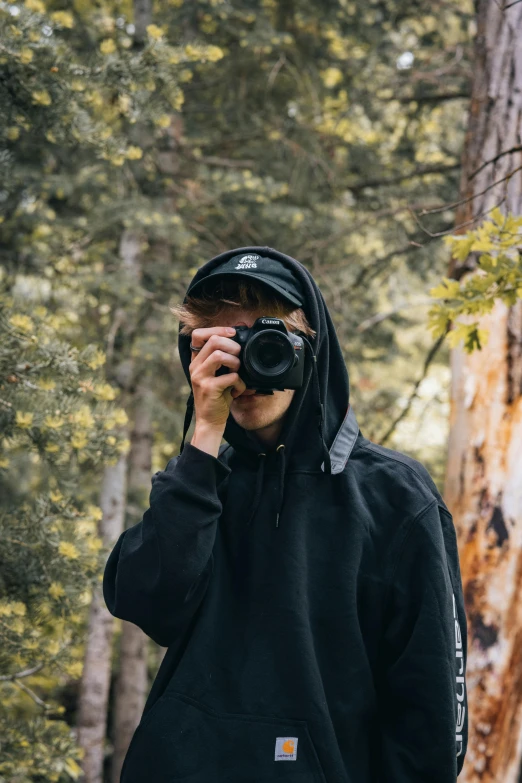 a person with a camera in the woods