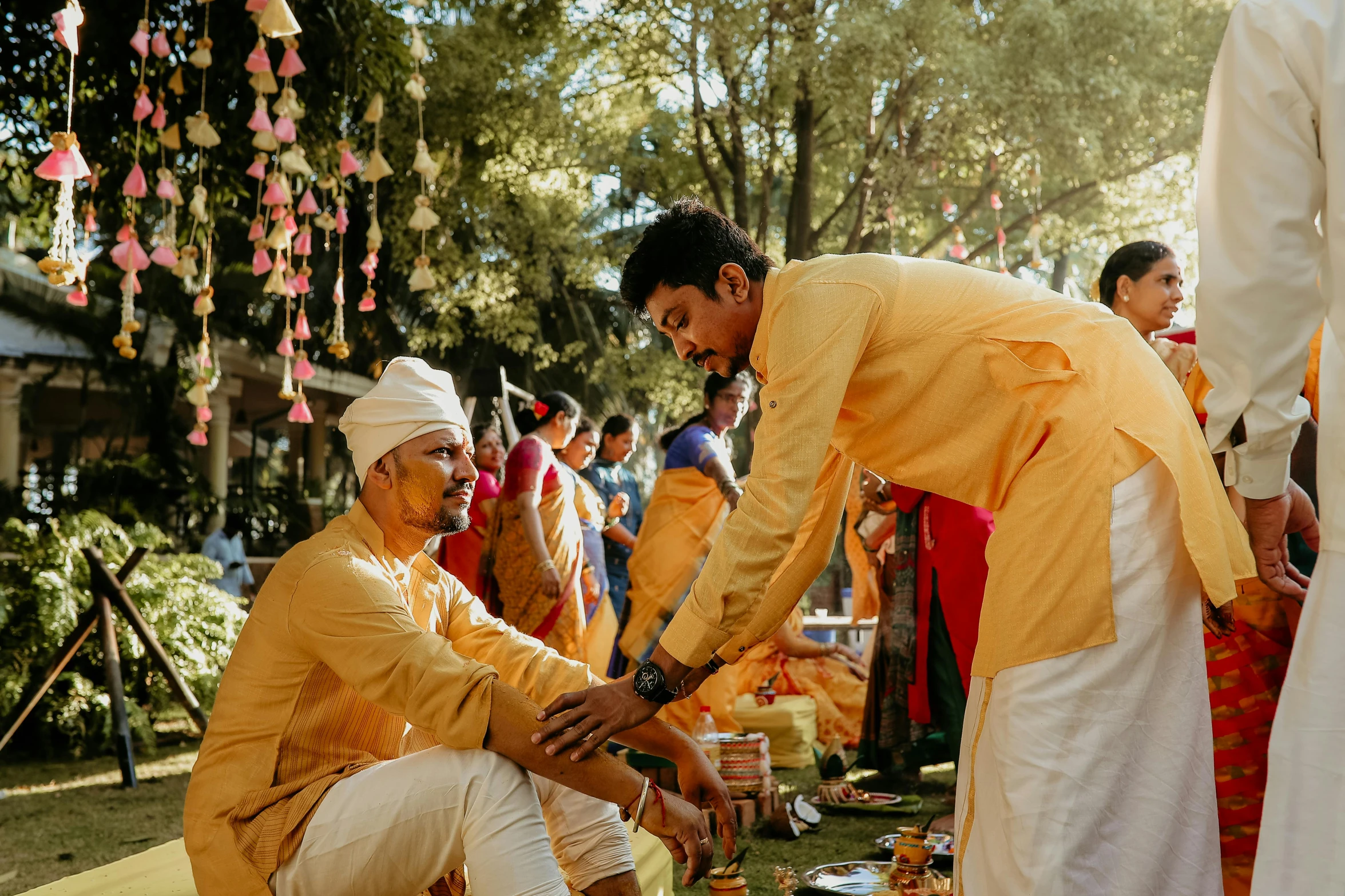 people with yellow outfits standing around at a wedding