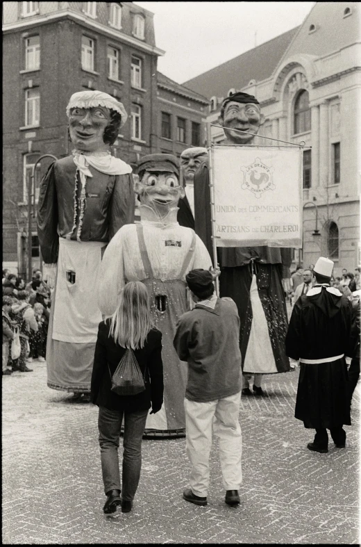 an older po of several statues being held by children