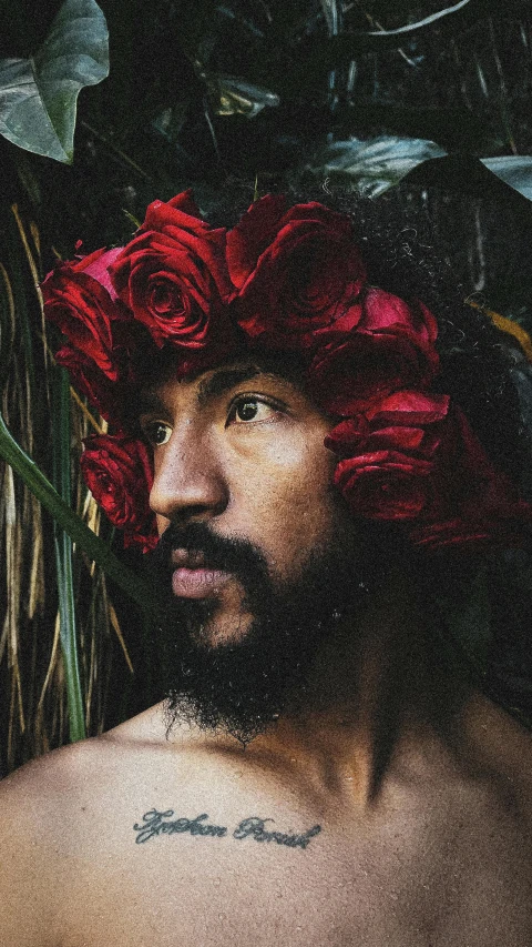 a man is wearing flowers on his head