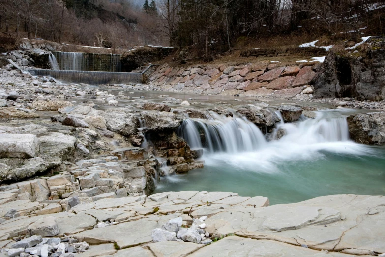 a large waterfall coming out of a rocky river