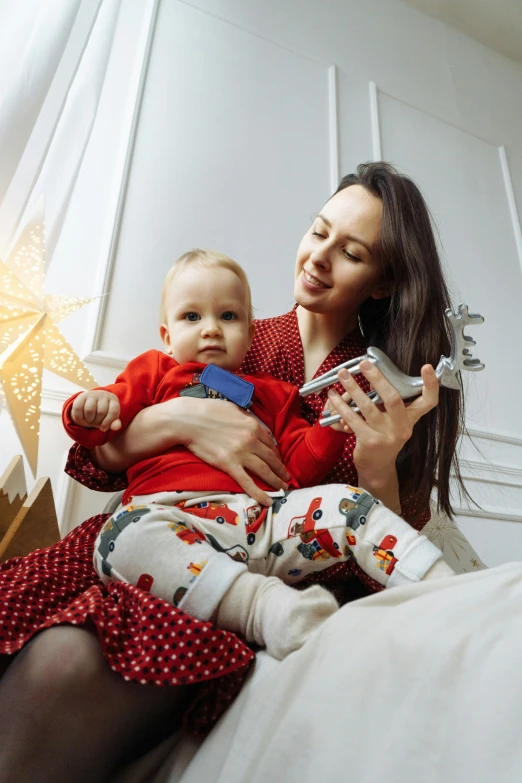 a woman holding her child on a bed