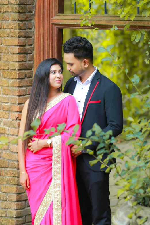 a couple standing outside in an indian - style setting