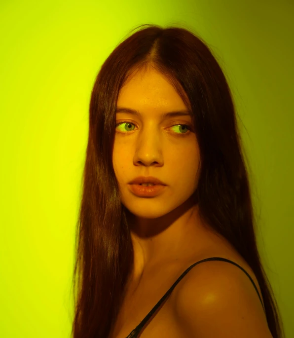a young woman has long dark hair and green eyes