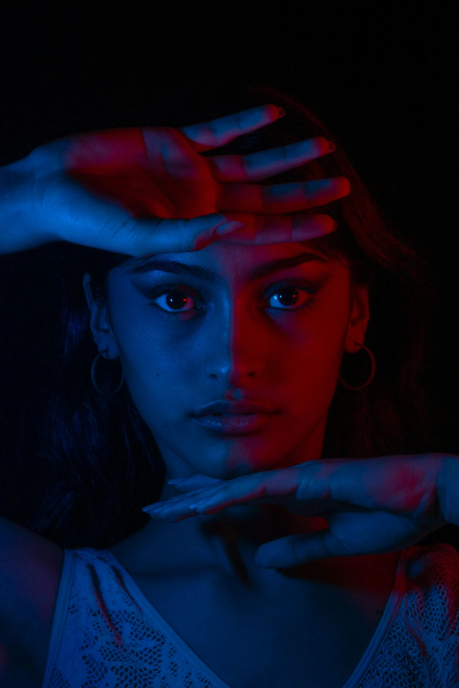 a woman holding her hands over her face with both hands