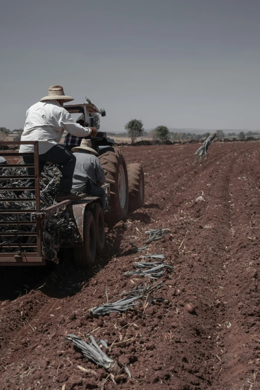 there is a tractor that has two men in it