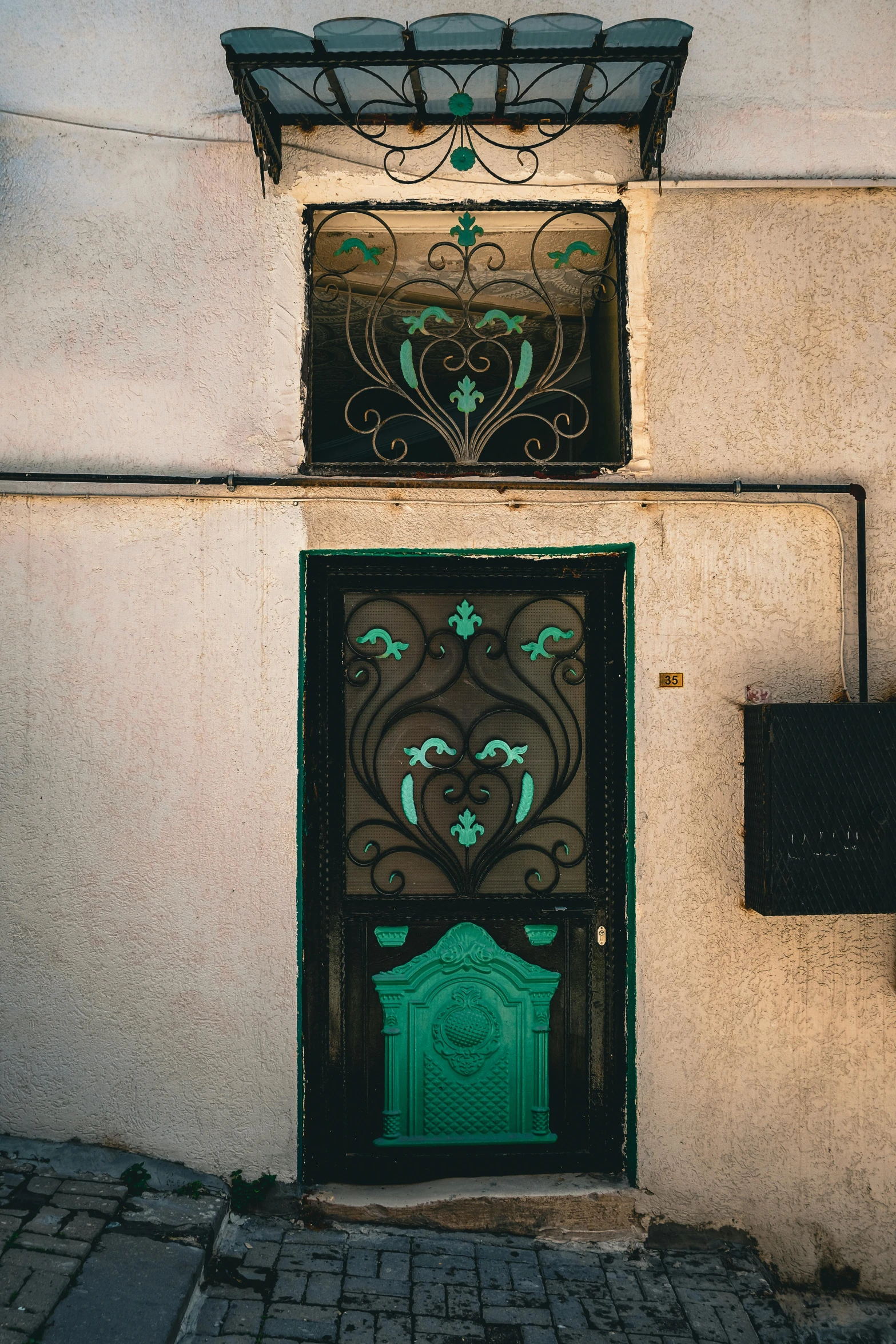 a building has green door and windows on it