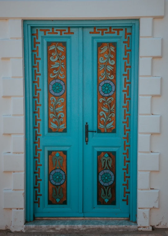 a light green door with an art deco door