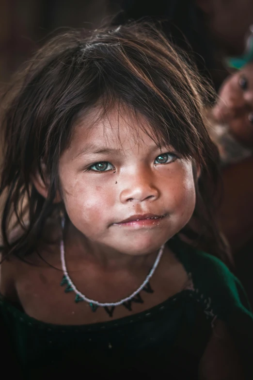 a little girl with necklaces that has been tied to her neck