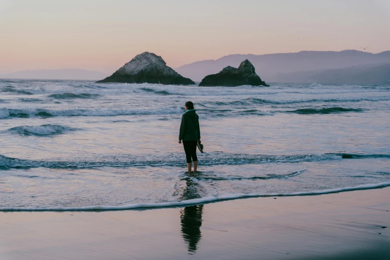 the man is in the water alone, standing by himself