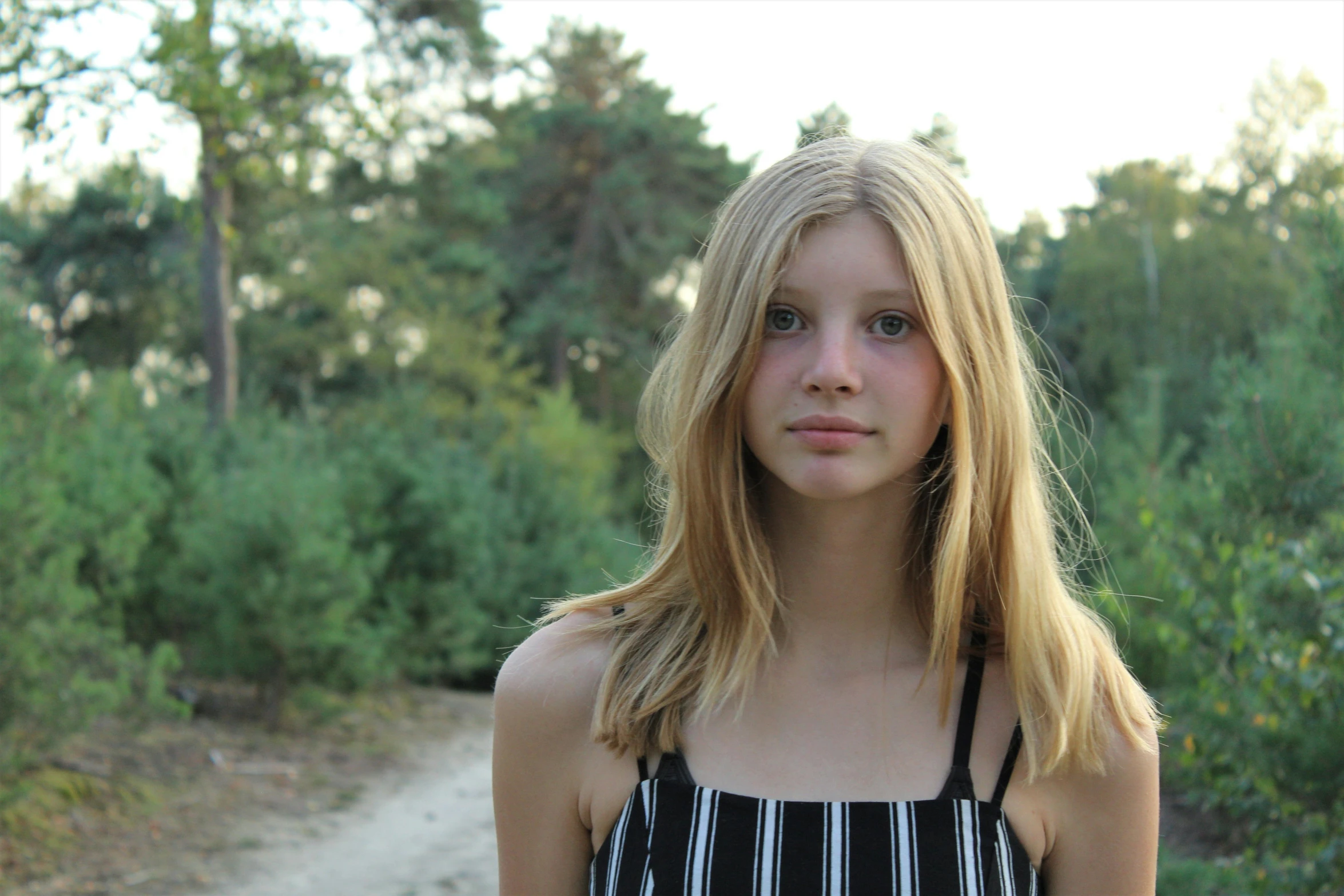 a woman posing on the trail for a picture