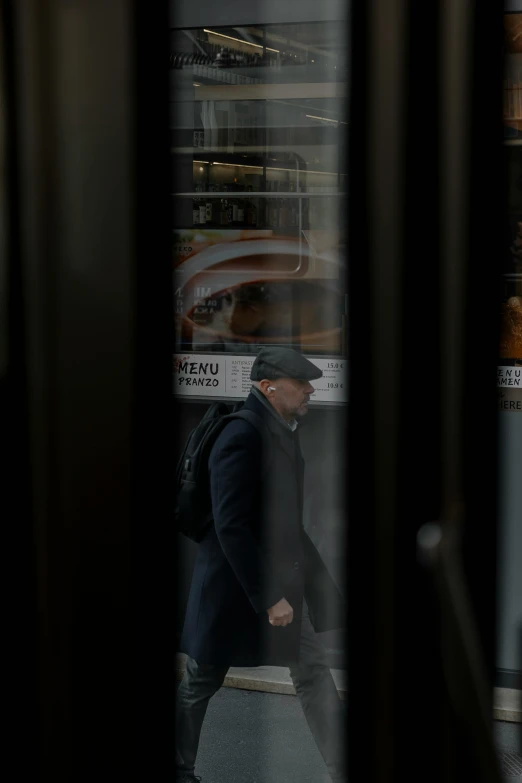 a man walking on a city street holding his luggage