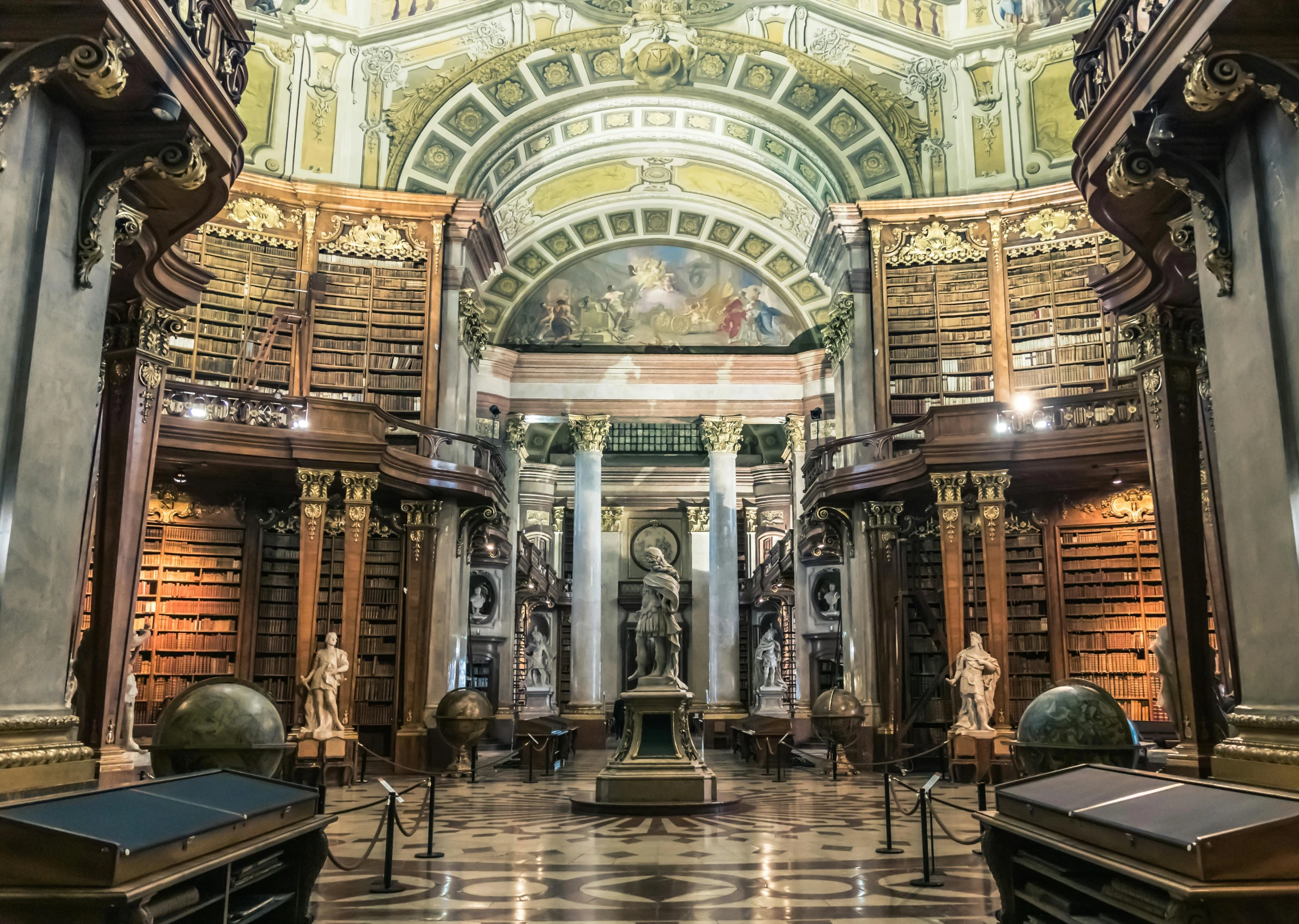 many books on a book shelf with people looking at it