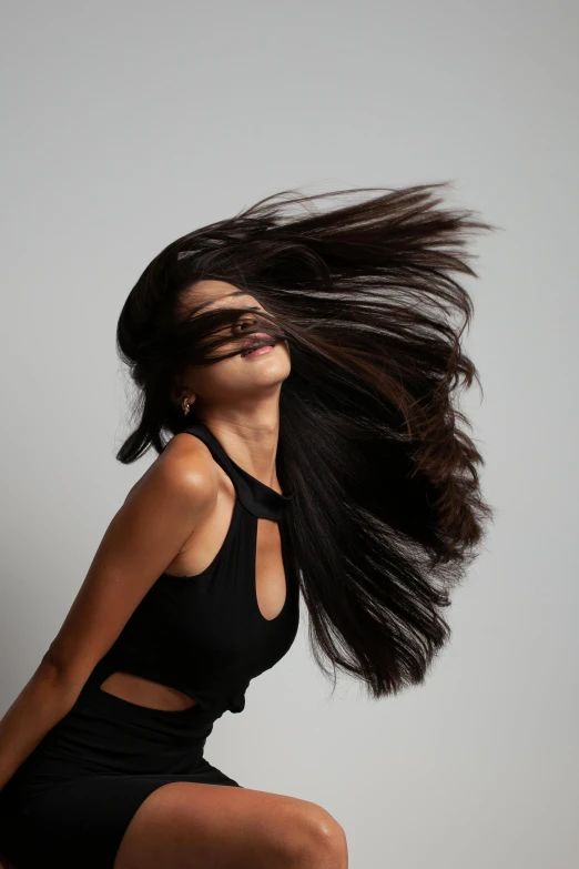 woman with long black hair blowing in the wind