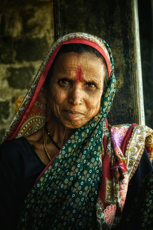 an old indian woman with a scarna on her head