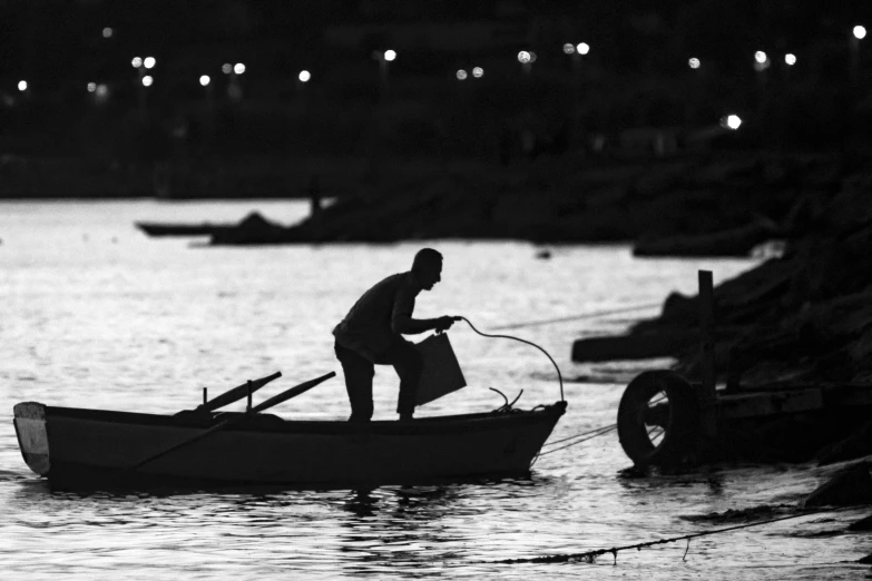 a man stands in a boat while washing himself