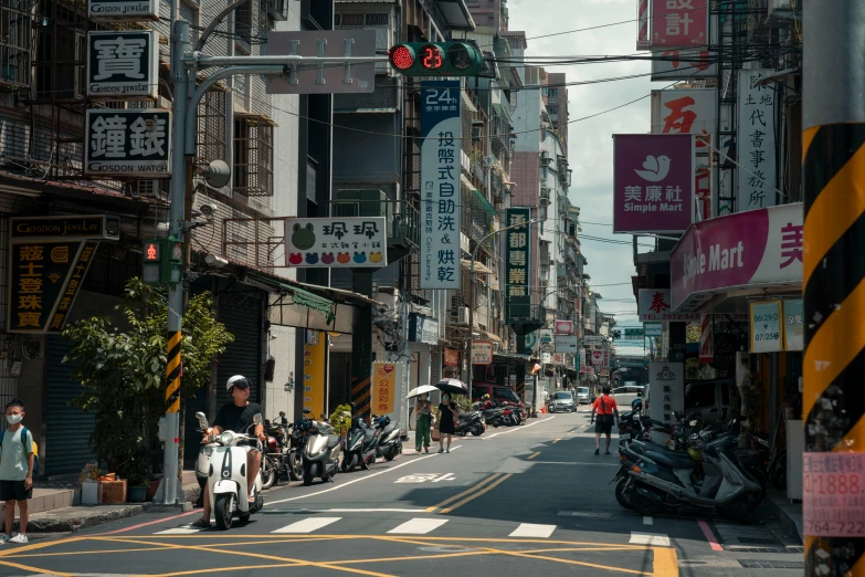 the bikers are riding down the street in the city