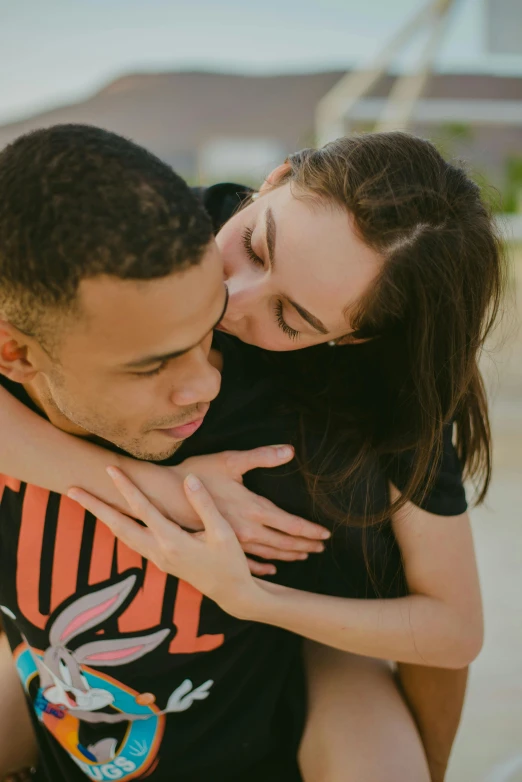 the couple are holding each other while looking at each other