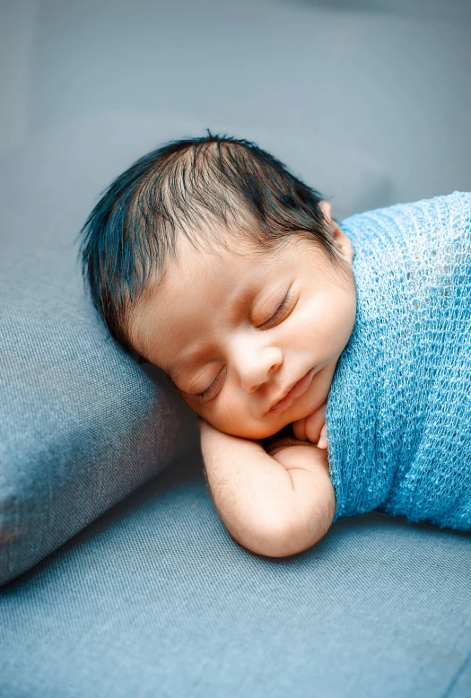 a baby is laying on top of a pillow