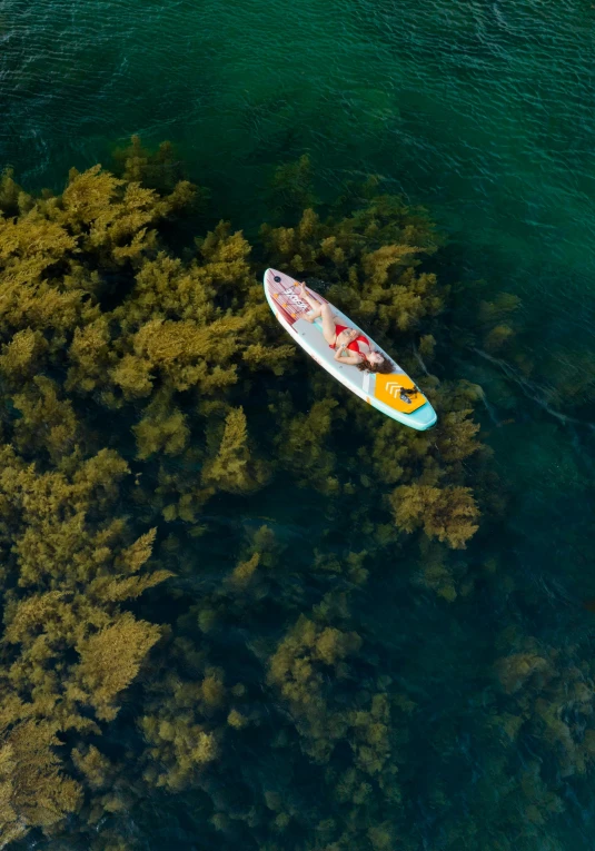 a view from above shows the white board and yellow kayak