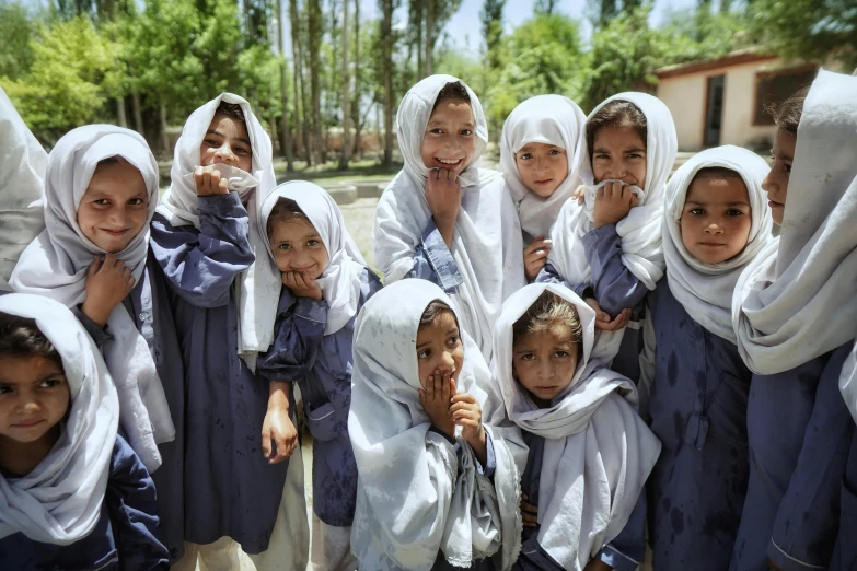 children with headscarves on all dressed in various poses