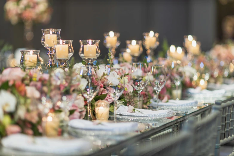 a table topped with pink flowers and candles