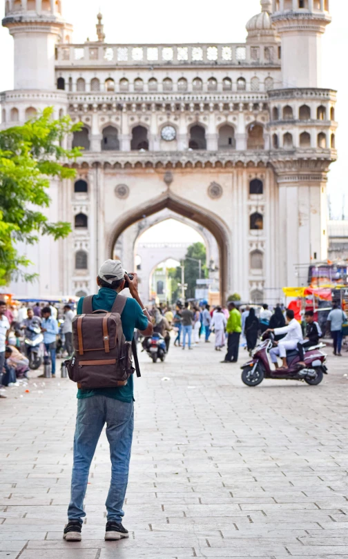 a man is standing in the middle of the walkway and taking a po