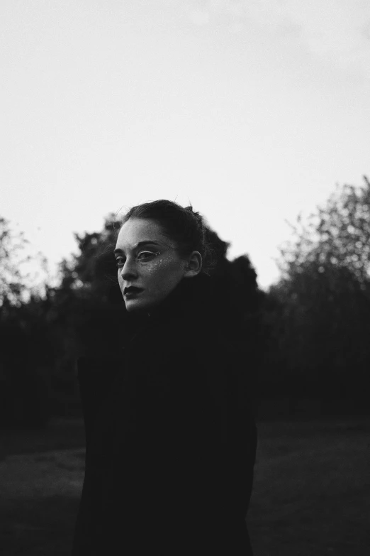 woman standing in field during dark with dark background