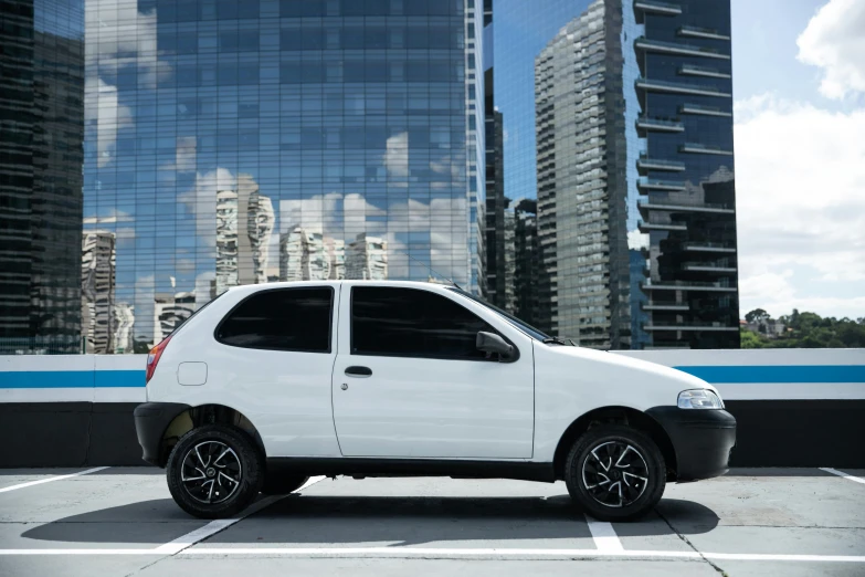 a white and black car parked next to a building