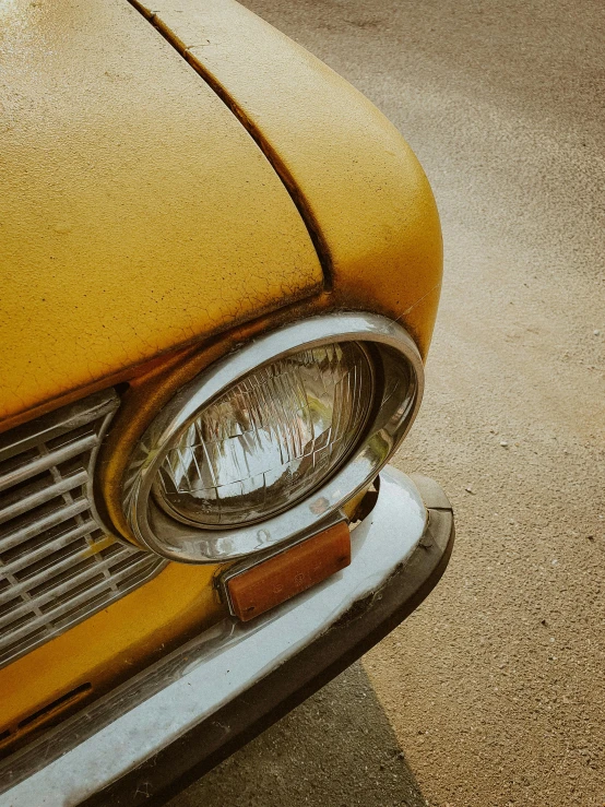 an old yellow car headlight with no light