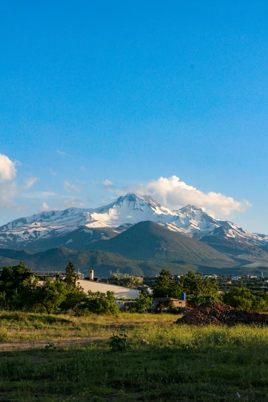 a large mountain range behind an urban area