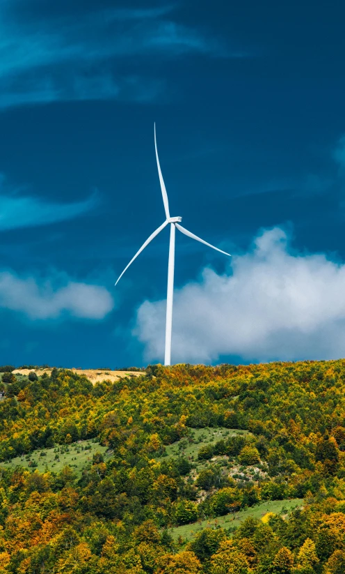 the three turbines are sitting on the hill