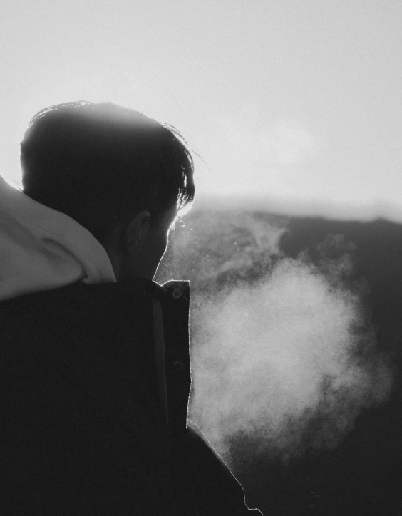 the person is staring at the smoke behind him
