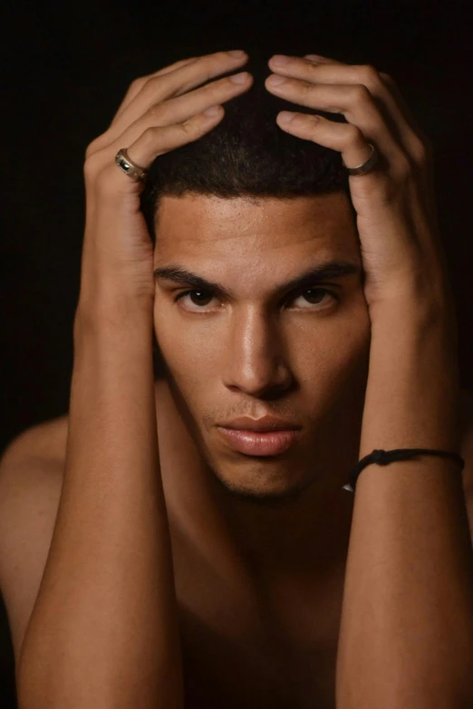 a close up of a person holding his hair