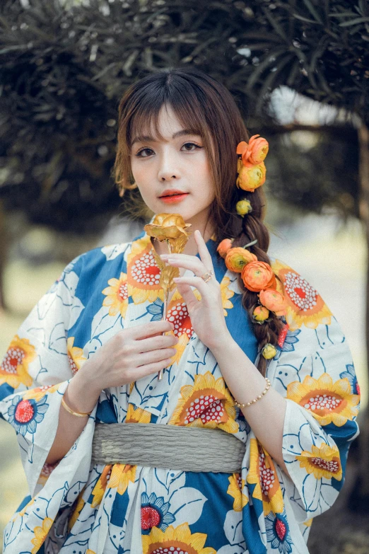 a woman with a flower on her head holding soing